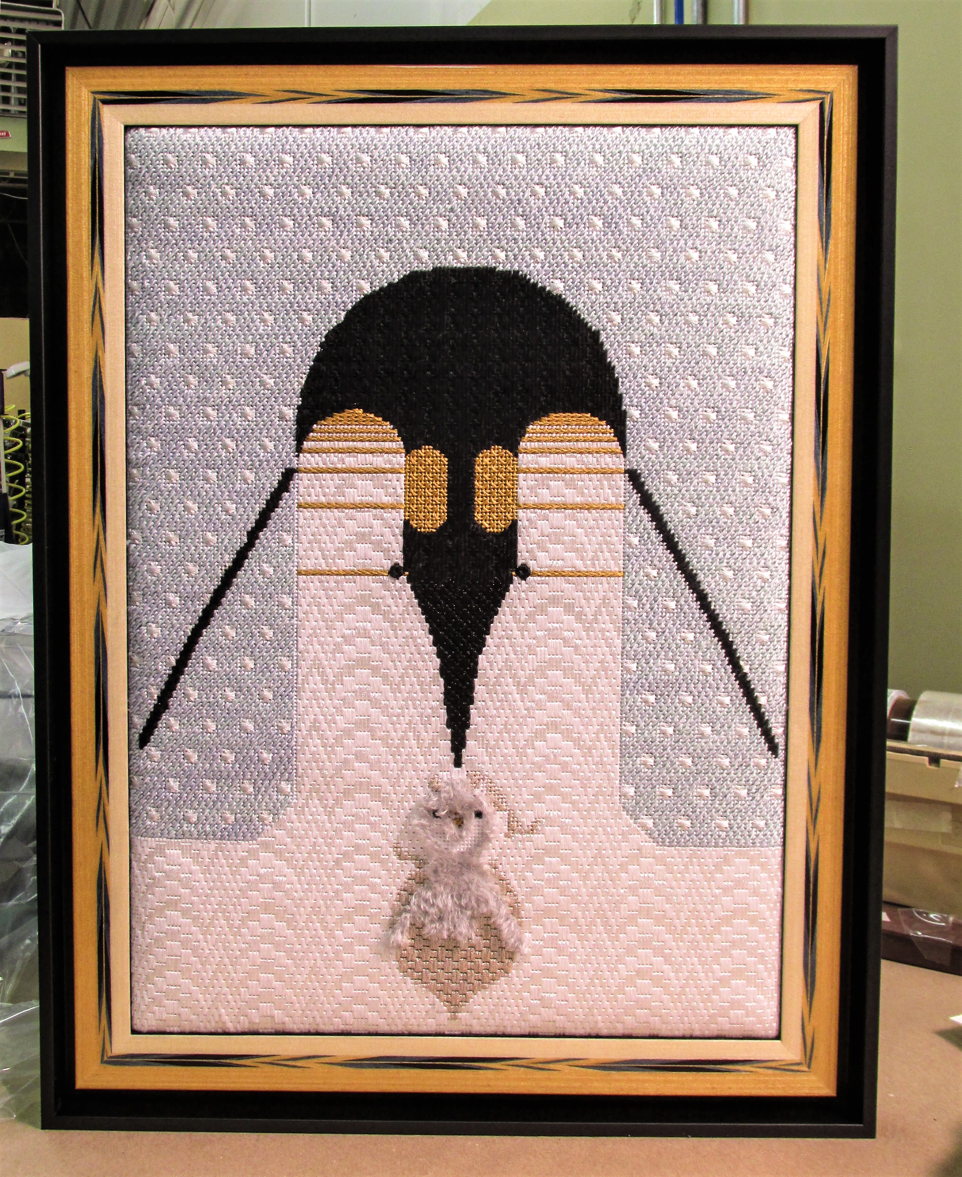 Framed needlepoint of two Penguins